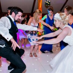Photography of funky dance moves of the fun loving bride with one of her friends at Brocket Hall wedding
