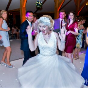 Photography of the bride loving every moment on the dancefloor as she parties the night away at her Brocket Hall wedding