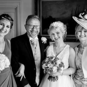 The bride & her family captured in a formal pose before the ceremony