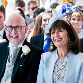 Smiling parents captured during the civil ceremony in the barn