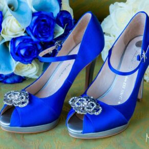 Brocket Hall wedding photography of the bride's blue shoes bouquet on the cobble stones