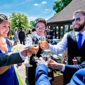Reportage shot of the guests charging their glasses captured on the terrace during the outdoor drinks reception