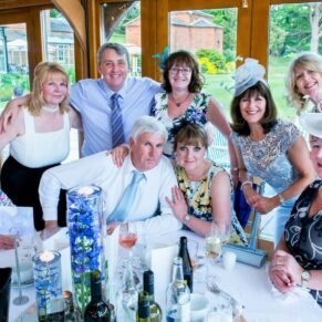 Relaxed friends group pose around a table
