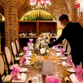 Cliveden House wedding photography - staff prepare the cellar room for the bridal party