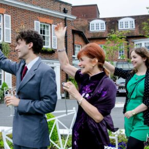 Guests waving the couple on their way for a romantic boat trip from the riverside at this Marlow marriage