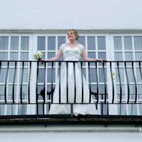 The bride looks out from her private terrace at the hotel
