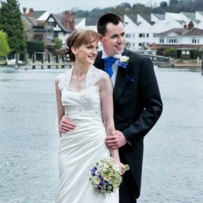The newlyweds with the River Thames and the town behind them