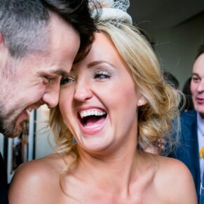 Two giggling wedding guests captured during the lively evening drinks reception at The Compleat Angler in Marlow