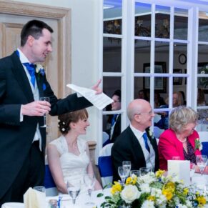 The groom's lively speech in progress with the bridal party enjoying the moment