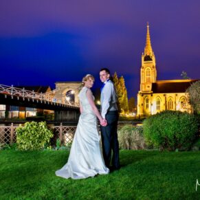 The newlyweds captured at dusk from the hotel's gardens with distant views over the River Thames and All Saints Church