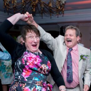 Photography of wedding guests enjoying the moment on the dancefloor as they let their hair down during an energetic dance routine at this lively Compleat Angler evening reception