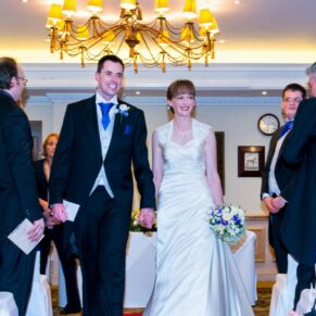 The newlyweds leaving the indoor civil ceremony with huge smiles on the faces