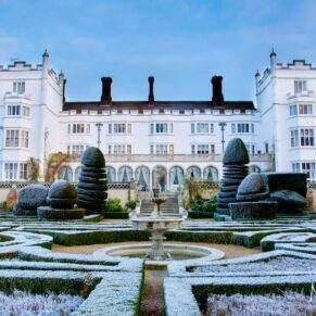 When the winter lighting is this fabulous I'm in absolute dreamland - Danesfield House has it all if you're looking for a fairy tale wedding venue - this frosty shot of the property was captured on the garden side of this luxury 5 star hotel - the crisp lighting captures every little detail of the venue and its glorious gardens in this striking architectural capture A stunning frosty blue sky wedding morning captured across the topiary towards the white fairy tale hotel exterior