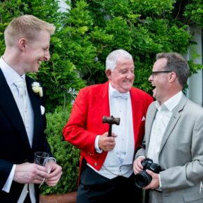 The toastmaster with some wedding guests enjoying a little banter during the drinks reception at Danesfield House