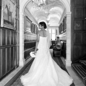 The bride showcasing the back of her stunning gown in the venue's grand corridor