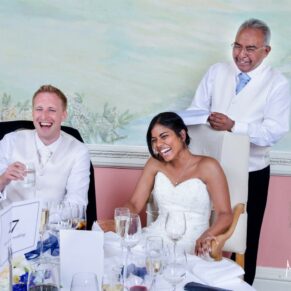 Dad's lively speech captured with a giggling and appreciative couple sat next to him