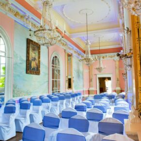 A wide interior view of the ceremony setup in the Versailles Room