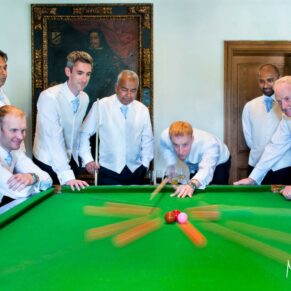 Bringing blur motion into a picture makes the image jump from the screen - this shot of the groom was one of favourites from this Danesfield House summer wedding - the lads loved doing it too as they got to show off their skills at the snooker table - the billiards table is located on the balcony in the Great Hall at this 5 star hotel - to achieve the result you see here the exposure was about half a second - but the guys had to stay mighty still The lads pre wedding ceremony take a shot at the billiards table with a little time exposure thrown in to ensure there's some movement as the balls fly across the table at Danesfield House Hotel