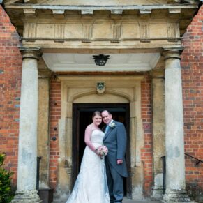The newlyweds in the grand entrance doorway at their Dorton House wedding