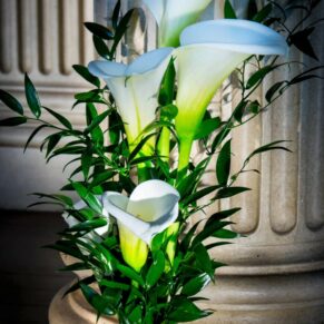 The bride's gorgeous lily bouquet placed on an upholstered chair