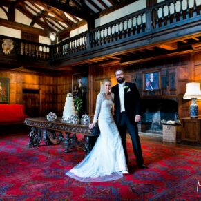 Full length portrait of the bride and groom in the majestic Great Hall