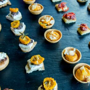 Yummy canapes straight from the kitchen placed on a slate platter