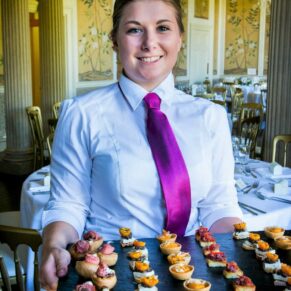 A member of staff with some delicious canapes for the garden drinks reception