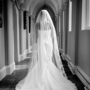 The back of the bride's gown captured in the Gothic Passage at this Grade II listed venue