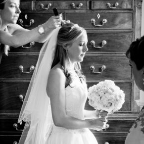 The bride having the final adjustments made to her hair pre ceremony in the bridal suite