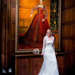 The bride beside the famous portrait of Elizabeth I in the stunning Great Hall