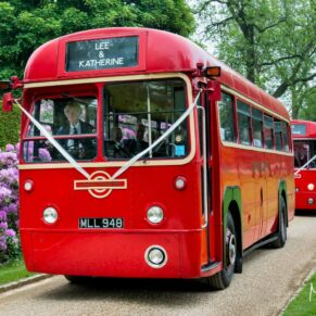 The red London buses arrive through the estate with the guests from the nearby church