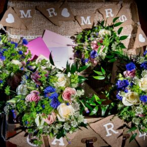 The bride's stunning flowers lit with dramatic effect on the gift table