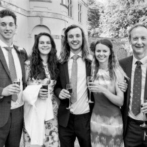 Some guests with a drink in hand pose for my camera with drinks in hand