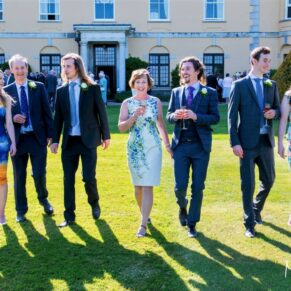 Some guests strolling across the lawns on a glorious summer's day