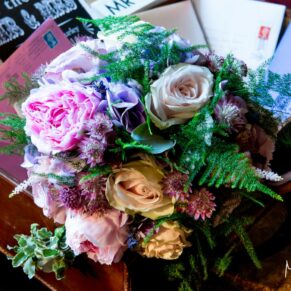 The bride's gorgeous summery bouquet placed on the gift table in the Great Hall