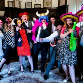 Guests dress up in funky outfits for the photo booth during the evening reception