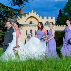 The bridal party strolling in the adjacent farmers meadow at the front of this historic venue