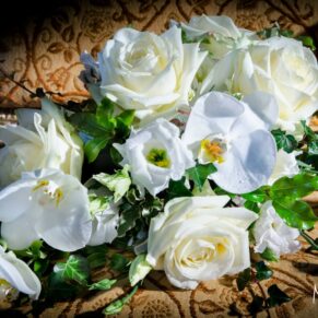 Stunning white orchid bouquet photographed on an antique gold chair