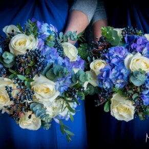Stunning white and blue bouquets held by the bridesmaids prior to the marriage ceremony