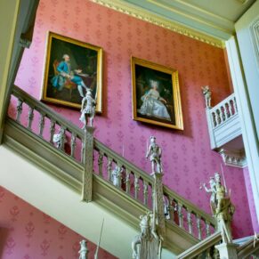 Hartwell House wedding photography - the grand staircase captured through the doorway