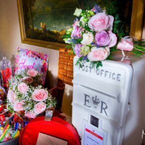 The wedding gift table and flowers captured with some dramatic lighting at Hartwell House