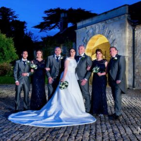 The newlyweds with their attendants at dusk captured in the Hartwell Court area of the hotel