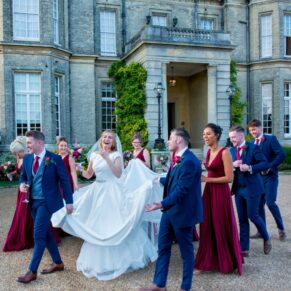 The bridal party walking away from the house to explore the fabulous grounds at Hedsor