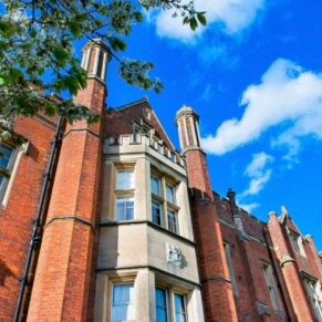 The dramatic exterior of the main house on a glorious blue sky wedding day
