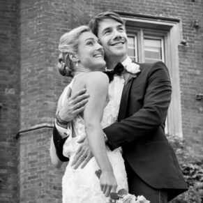 Black and white portrait of the newlyweds looking off into the distance