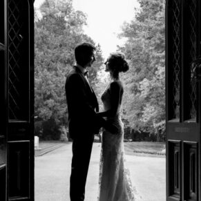 Dramatic silhouette shot of the bride and groom in the entrance doorway on the Latimer Estate