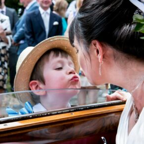 This young lad presented a lovely surprise kiss for the bride through the car window