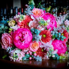 A gorgeous and vibrant floral arrangement captured with window lighting at this Le Manoir Aux Quat Saisons wedding