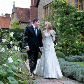 The newlyweds taking a stroll with Le Manoir Aux Quat Saisons in the background