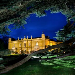 The historic medieval property captured at dusk with floodlighting illuminating this Buckinghamshire marriage venue